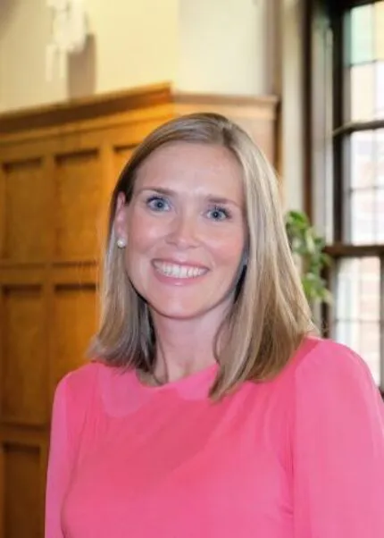 Kelly Dunlop, Religious, Secular, Spiritual and Interfaith Engagement Lead. Kelly has blonde hair and is wearing a pink shirt.