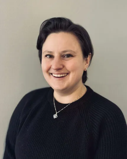 Marisa Quiery, Program Manager for Religious, Secular and Spiritual Life. She has short brown hair and is wearing a black sweater.